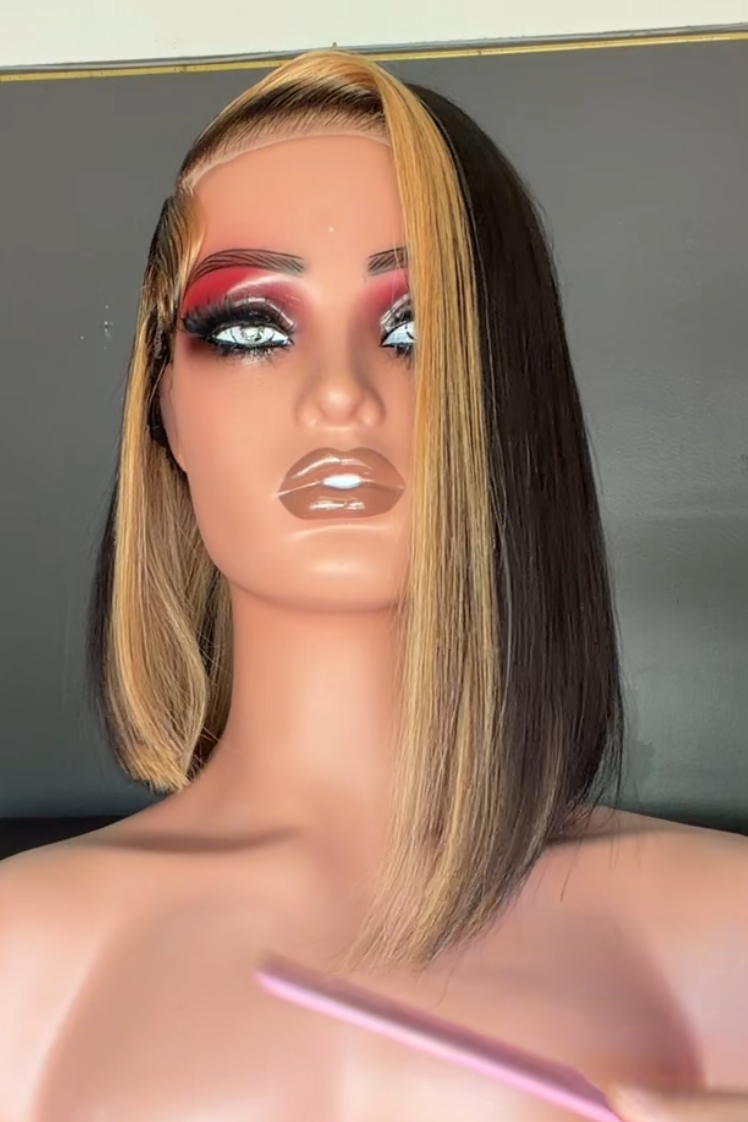 Mannequin head with makeup on a tripod in a room setting